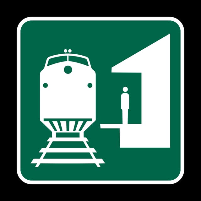 Train Station sign - Shows the direction or location of a passenger rail station for boarding trains or making connections.