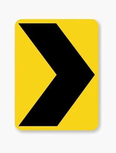 Chevron Right sign - Emphasizes a sharp change of direction to the right along a curve or turn.