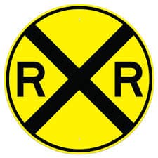 Railroad Crossing sign - Indicates active train tracks ahead; slow down and yield to any approaching trains.
