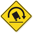 Truck Rollover sign - Warns of a curve or condition where high-profile vehicles are at increased risk of rolling over.